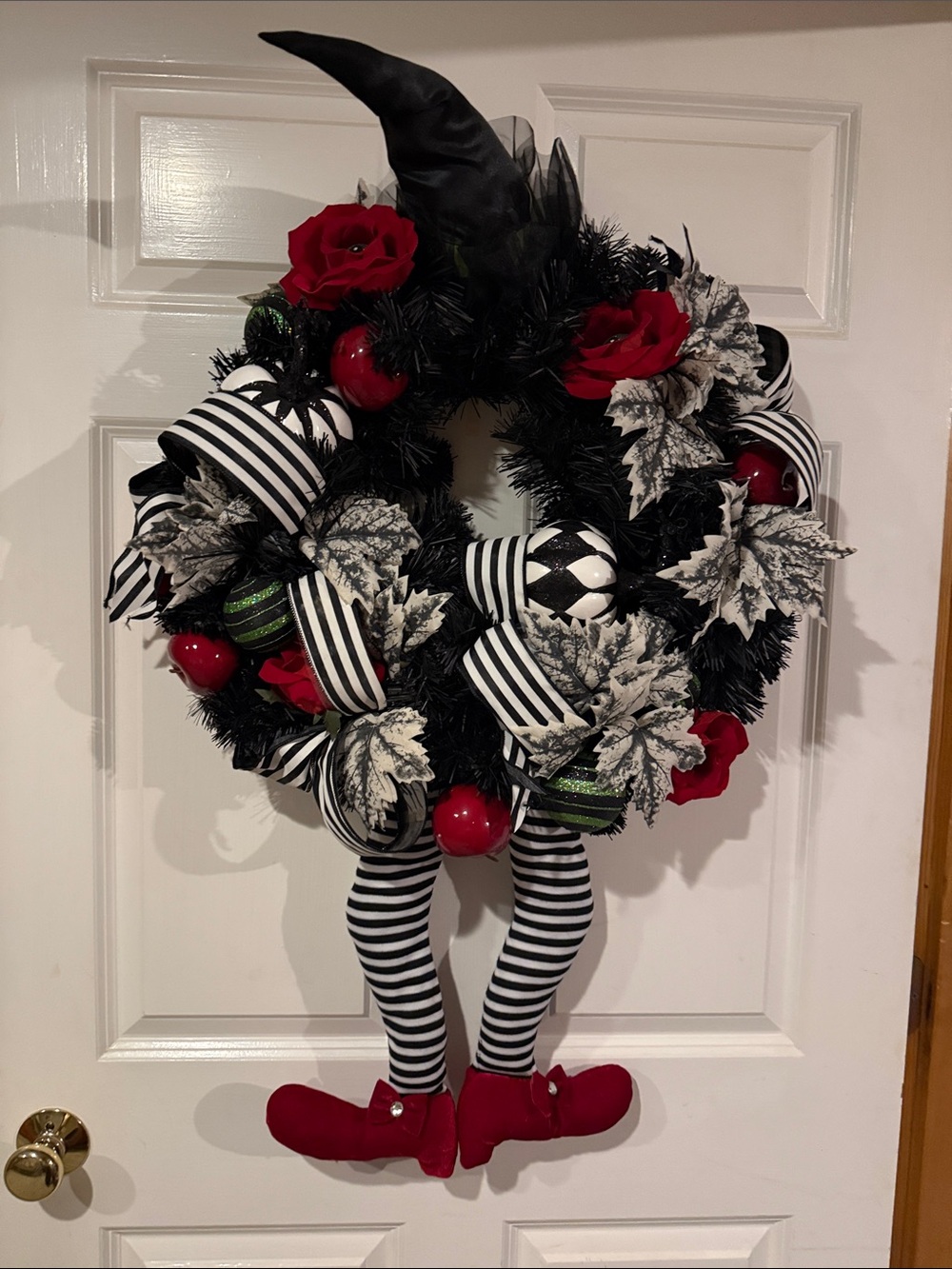 Black Witch Wreath with Red Accents and Striped Ribbon